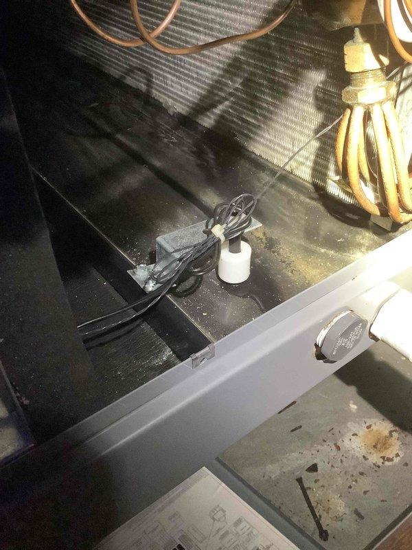 Responded to service call for air conditioning system repeatedly tripping circuit breaker and unable to operate. Upon inspection, discovered condensate drain pan had excessive water accumulation triggering the safety float switch, which was preventing system operation as designed. Cleared blockage in condensate drain line, verified proper drainage, tested float switch functionality, and confirmed system restored to normal operation without tripping breaker. Unit cooling properly upon departure.