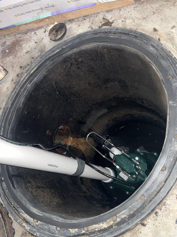 Completed second service call to remove and replace failed ejector pump system. Removed existing ejector pump, check valve, and pit lid from sump basin and properly disposed of old equipment. Installed new 1/2 horsepower ejector pump with float switch assembly in basin with standing water. Connected discharge piping to new check valve and secured new pit lid. Verified proper pump operation and float switch functionality. System tested and confirmed operational for basement wastewater removal. Installation includes 3-year warranty on pump and 1-year parts and labor warranty.