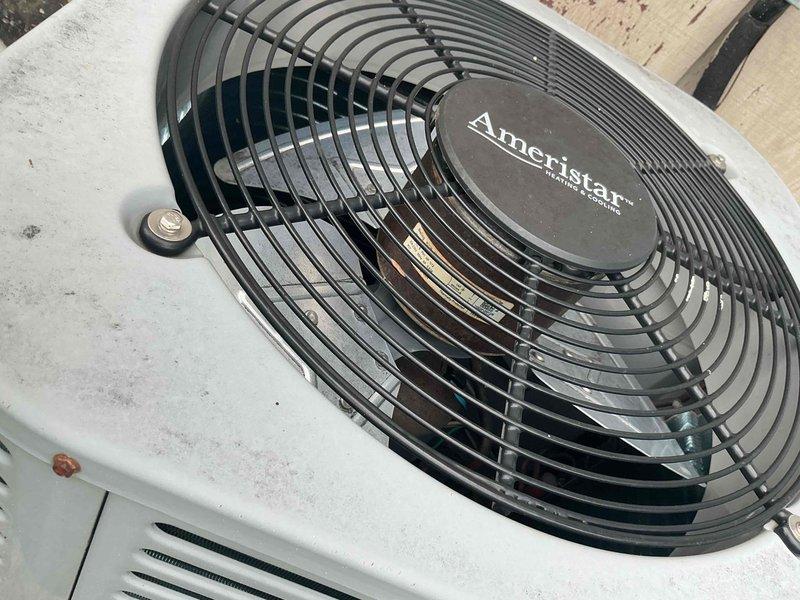 Completed comprehensive tune-up service on 8-year-old Ameristar outdoor condensing unit per scheduled maintenance protocol. Performed visual inspection of unit exterior, noting normal weathering and surface oxidation consistent with age. Removed access panel and inspected internal electrical components including capacitor, contactor, and control module. Observed green corrosion buildup on capacitor surface and general accumulation of dirt and debris within cabinet. Cleaned electrical connections, verified proper wire terminations on all circuits, and tested capacitor functionality. Inspected fan assembly and motor operation, confirmed proper rotation and airflow through top discharge grille. Checked refrigerant pressures and system performance parameters to ensure optimal cooling efficiency.