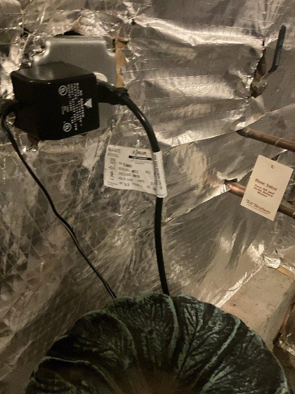 Completed comprehensive sump pump inspection in basement utility area. Verified proper operation of sump pump unit, checked discharge piping configuration including white PVC U-bend assembly, inspected pit condition and water level controls, and confirmed electrical connections were secure. All components found to be functioning within normal parameters with no immediate service needs identified.