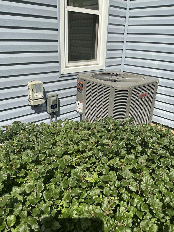 Conducted one-week post-installation follow-up phone call to verify proper operation of newly installed Lennox air conditioning system. Confirmed outdoor condenser unit is functioning correctly with no operational concerns reported, and documented equipment condition with photographic records showing proper installation on concrete pad with adequate clearance and professional electrical disconnect box mounting.