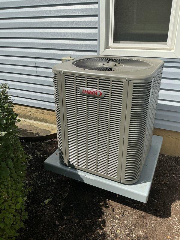 Conducted one-week post-installation follow-up phone call to verify proper operation of newly installed Lennox air conditioning system. Confirmed outdoor condenser unit is functioning correctly with no operational concerns reported, and documented equipment condition with photographic records showing proper installation on concrete pad with adequate clearance and professional electrical disconnect box mounting.