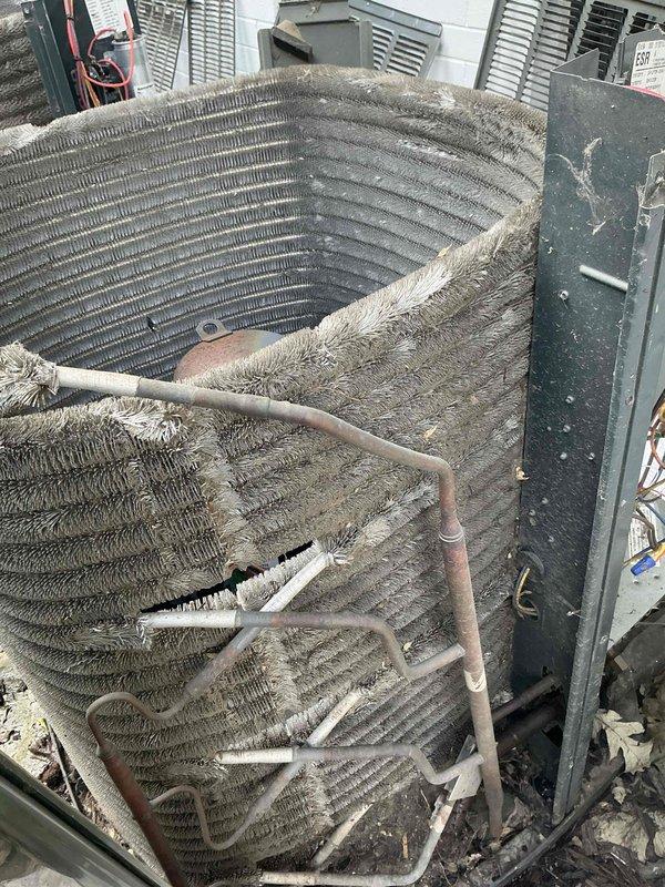 Completed comprehensive BFMA tune-up service on 9-year-old air conditioning system, including inspection of two AC units and compressor sump pump. Performed thorough cleaning of heavily soiled outdoor condenser coils which exhibited significant accumulation of dirt, dust, and organic debris that was restricting airflow and reducing system efficiency. Inspected condenser unit components including compressor, refrigerant lines, electrical connections, and mounting hardware. Noted oxidation on copper refrigerant lines and general wear consistent with equipment age. Verified proper operation of all mechanical components and ensured adequate airflow through cleaned coil assembly to restore optimal cooling performance.