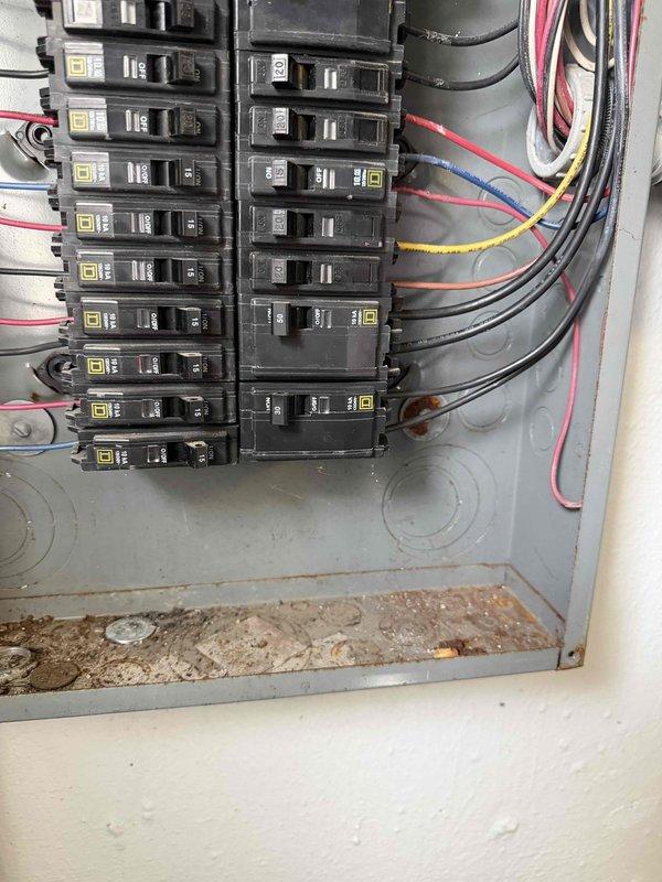 Responded to no cooling complaint on AC unit under warranty installed by Blue Frost. Upon arrival, inspected electrical panel and circuit breakers serving the system. Found 30-amp double-pole breakers in proper operational position with correct voltage supply. Panel showed signs of age with rust staining, debris accumulation, and weathering but breakers were functional. Documented electrical connections and panel condition with photos for warranty documentation purposes.
