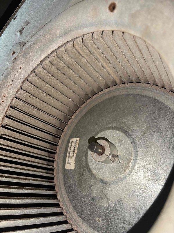 Responded to service call for noise complaints on two 20-year-old air conditioning systems. Upon inspection, discovered significant dust and debris accumulation on blower wheel assembly, which was causing operational noise. Accessed blower motor compartment and documented condition of squirrel cage fan showing heavy buildup on blades and housing. Inspected blower motor assembly, electrical connections, capacitor, and mounting hardware. Both systems exhibited normal wear consistent with age and lack of regular maintenance. Recommended thorough cleaning of blower components and routine preventive maintenance to restore quiet operation and maintain system efficiency.