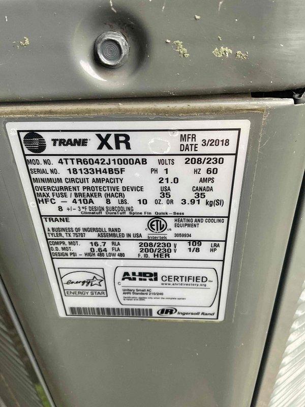 Completed comprehensive BFMA tune-up on Trane XR model 4TTR6042J1000AB air conditioning system, manufactured March 2018, with 208/230V electrical specifications. Performed standard preventive maintenance procedures including inspection of condenser unit, verification of proper airflow through vertical louvers and top-mounted fan assembly, and confirmation of refrigerant line connections. Unit found to be in operational condition with all components functioning within manufacturer specifications.