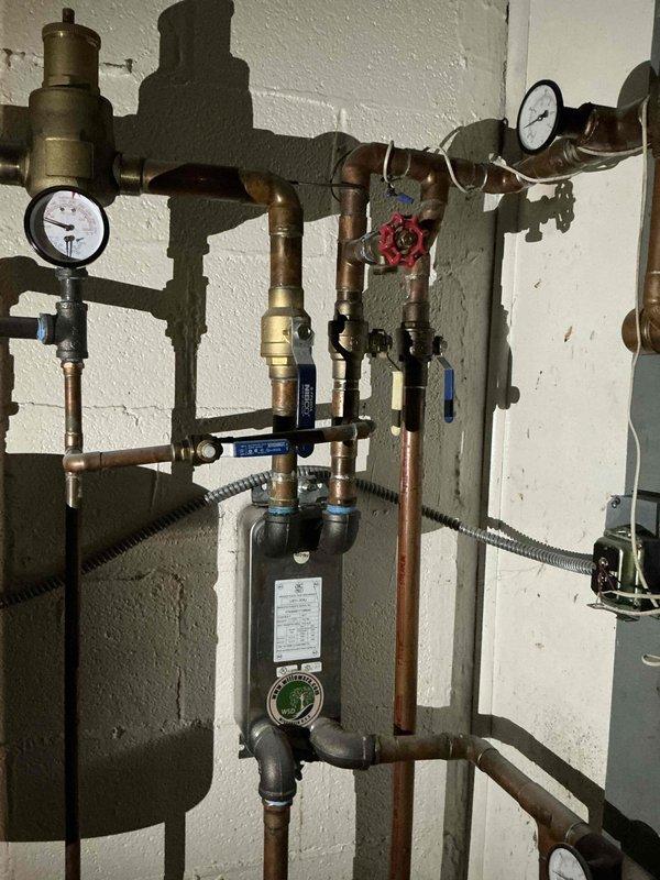 Performed boiler service for property undergoing driveway renovation with existing snowmelt system. Capped off snowmelt zone to accommodate contractor's excavation work and driveway replacement. Inspected existing boiler plumbing assembly including multiple zone valves, pressure gauges, heat exchanger connections, and copper piping with press fittings installed by previous contractor.