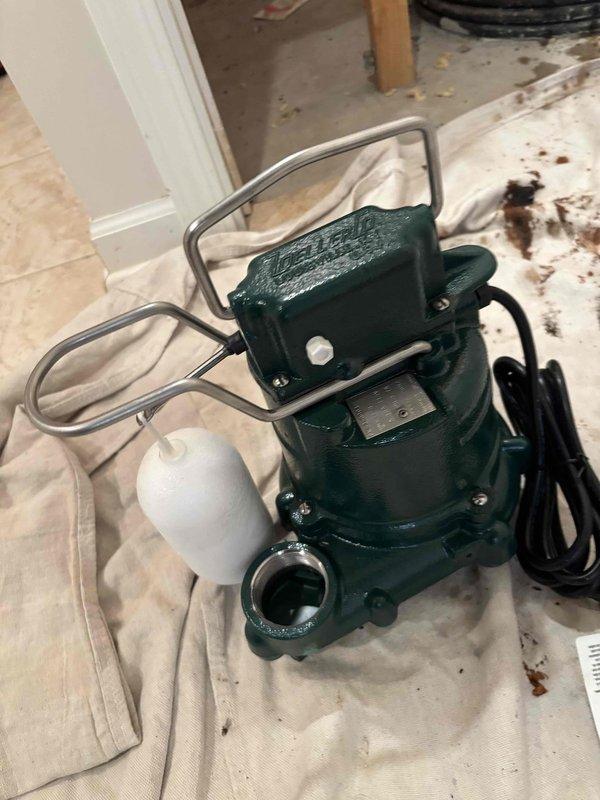 Installed new M53 sump pump system with complete kit assembly in designated sump basin. Positioned pump unit on basin floor with properly configured float switch mechanism to ensure automatic activation at appropriate water levels. Connected discharge piping and verified all mounting hardware secured correctly within the ribbed plastic sump pit. Tested pump operation and confirmed proper float function and water evacuation through discharge line.