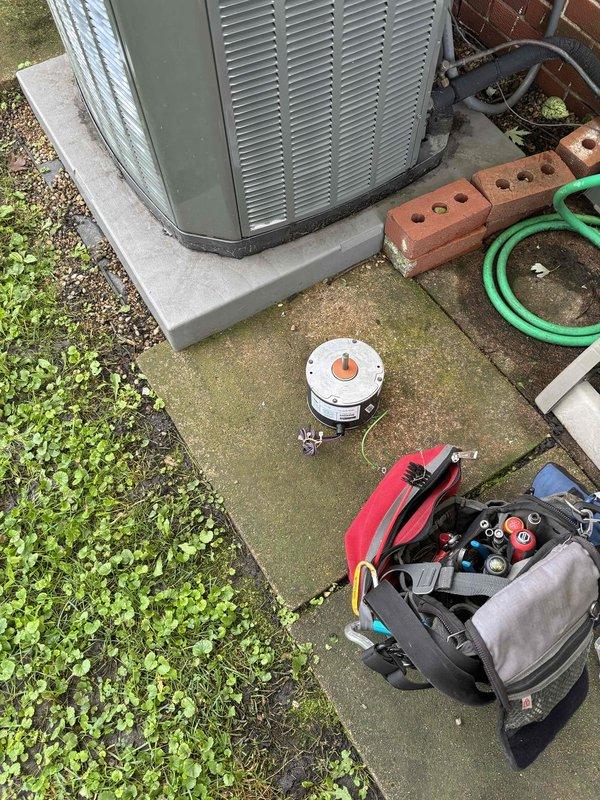 Replaced defective condenser fan motor on outdoor HVAC unit under manufacturer's and Blue Frost labor warranty. Removed old motor assembly, installed new motor, reassembled unit, and verified proper operation with all components functioning correctly.