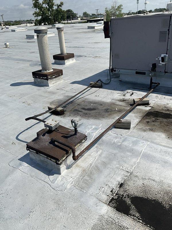 Conducted site assessment for rooftop unit replacement, documenting existing electrical breaker specifications and gas piping dimensions. Photographed current RTU installation, heavily corroded support structure, gas line connections, and rooftop conditions to provide accurate specifications for equipment replacement planning.