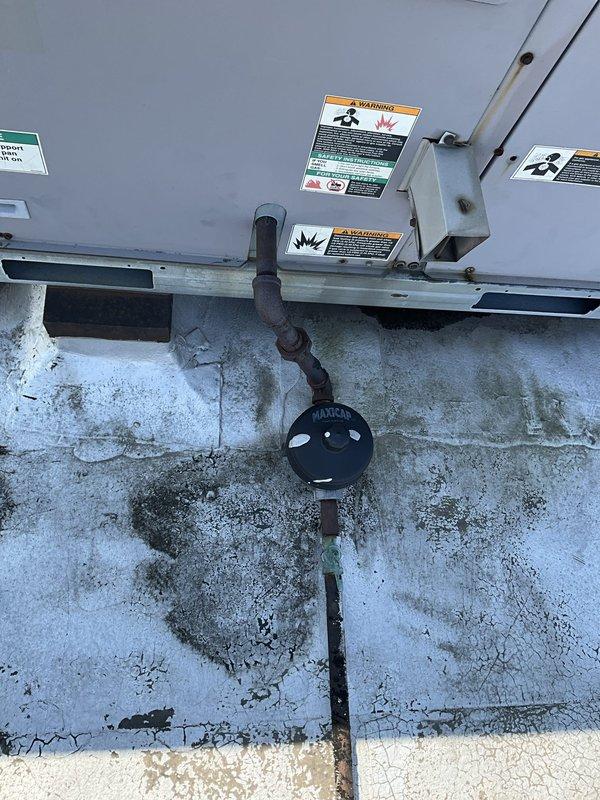 Conducted site assessment for rooftop unit replacement, documenting existing electrical breaker specifications and gas piping dimensions. Photographed current RTU installation, heavily corroded support structure, gas line connections, and rooftop conditions to provide accurate specifications for equipment replacement planning.