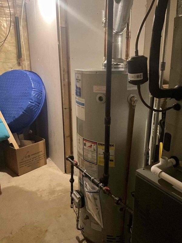 Removed and properly disposed of existing residential water heater from basement location. Installed new 75-gallon natural gas Bradford White water heater with 6-year tank warranty and 1-year parts and labor warranty. Modified and connected all required utilities including natural gas line, cold water supply, hot water distribution, and flue venting system to meet current code requirements. Installed necessary safety components including temperature and pressure relief valve with proper discharge piping, gas shut-off valve, and expansion tank. Tested all connections for leaks, verified proper combustion and venting operation, and confirmed unit functionality before completion.
