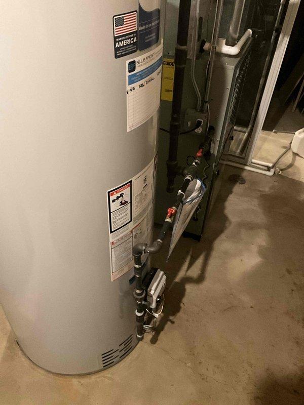 Removed and properly disposed of existing residential water heater from basement location. Installed new 75-gallon natural gas Bradford White water heater with 6-year tank warranty and 1-year parts and labor warranty. Modified and connected all required utilities including natural gas line, cold water supply, hot water distribution, and flue venting system to meet current code requirements. Installed necessary safety components including temperature and pressure relief valve with proper discharge piping, gas shut-off valve, and expansion tank. Tested all connections for leaks, verified proper combustion and venting operation, and confirmed unit functionality before completion.