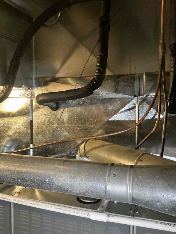 Provided and installed Trane 10-ton condensing unit with hail guard protection and three 4-ton uncased evaporator coils utilizing R454B refrigerant for commercial HVAC application. Flushed existing line sets with R-11 to remove contaminants and ensure system cleanliness prior to charging. Installed new outdoor fuse box with 50-amp fuses and verified 8-gauge wire whip compliance per NEC Table 25C requirements for air conditioning applications. Fabricated and brazed refrigerant line connections using 1 1/8" fittings at condensing unit. Applied Armaflex insulation to refrigerant lines for thermal efficiency and condensation prevention. Reconnected system to existing thermostat and electrical infrastructure. Charged system with refrigerant oil and R454B refrigerant to manufacturer specifications. Completed operational verification and system startup, confirming proper cooling performance, electrical connections, and refrigerant pressures across all three zones. System operating within norm