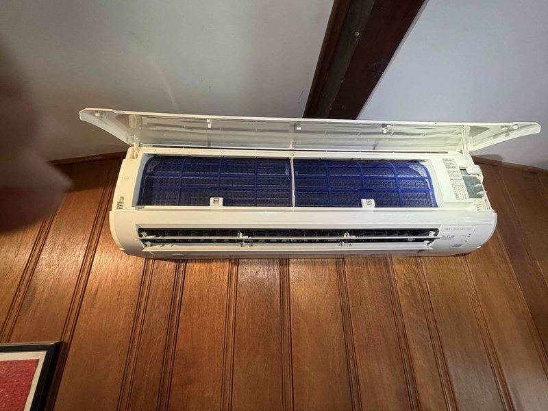 Performed system restoration on wall-mounted air conditioning unit. Inspected internal components including evaporator coil assembly, drain pan, and air filter, noting evidence of water staining and accumulated debris in base pan. Addressed system issues to restore proper operation and functionality per customer's specific service request.
