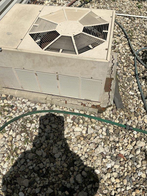 Conducted on-site evaluation of existing outdoor condensing unit and indoor coil system for replacement estimate. Unit is 25+ years old and beyond economical repair. Inspected outdoor condenser positioned on concrete pad with gravel surround, noting weathered cabinet condition, aged fan assembly with hexagonal guard, and deteriorated metal casing consistent with extended service life. Evaluated indoor coil location in basement utility area with existing ductwork connections. Documented current system configuration including refrigerant line routing, electrical conduit placement, and mounting specifications. Assessed installation area conditions and confirmed adequate clearances for replacement equipment. Provided comprehensive replacement options for complete air conditioning system including new condensing unit and evaporator coil to restore cooling capacity and improve energy efficiency.