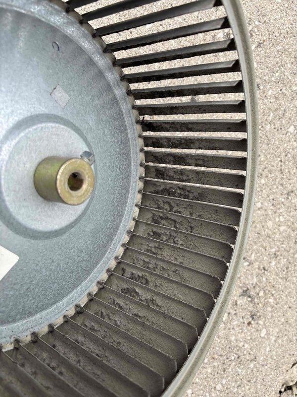 Removed and thoroughly cleaned blower wheel assembly that had accumulated significant dirt and dust buildup affecting system performance. Replaced defective damper component with new part. Reassembled unit, verified proper airflow operation, and confirmed system returned to normal functionality.