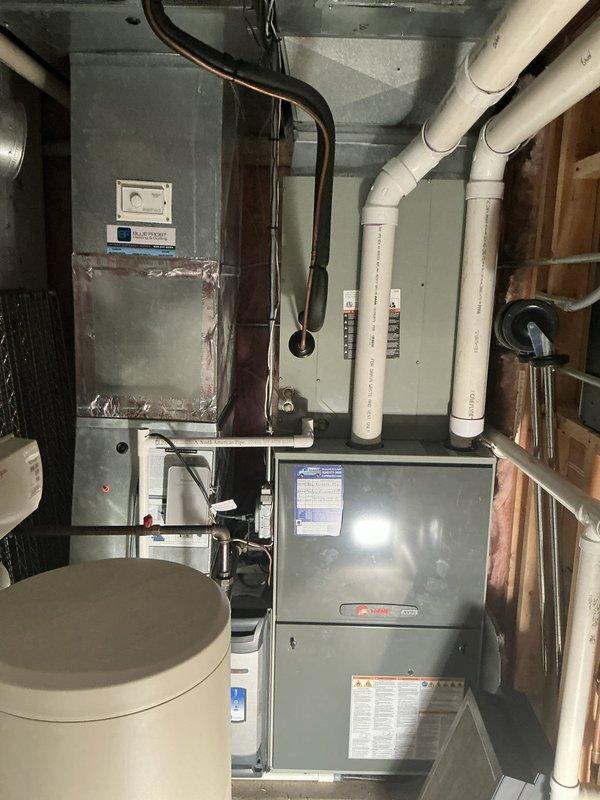 Completed full HVAC system replacement installing Lennox EL297 high-efficiency furnace rated at 135,000 BTUs and 97% AFUE, paired with Lennox EL15 air conditioning unit rated at 15 SEER2. Installed Lennox S40 smart thermostat for system control and integrated Aprilaire 1210 whole-home humidifier with powered operation as part of premium installation package. Reused existing refrigerant lineset, return air drop, and furnace venting to minimize installation modifications. Installed Siemens 50A2P circuit breaker for electrical service to outdoor condenser unit. Mounted indoor furnace unit in basement mechanical room with proper clearances and connected refrigerant lines to outdoor condenser positioned on exterior platform. Verified all electrical connections, tested system operation across heating and cooling modes, and confirmed proper airflow and temperature differentials. System commissioned and left in full operational status.
