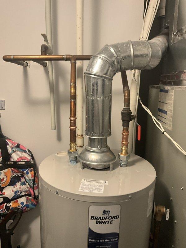 Removed and properly disposed of existing residential water heater. Installed new 40-gallon natural gas Bradford White water heater with slim profile design in utility room. Modified and reconnected all gas lines, water supply lines, and flue venting to accommodate new unit specifications. All copper piping, brass fittings, and galvanized ductwork connections were secured and tested for proper operation and safety compliance.