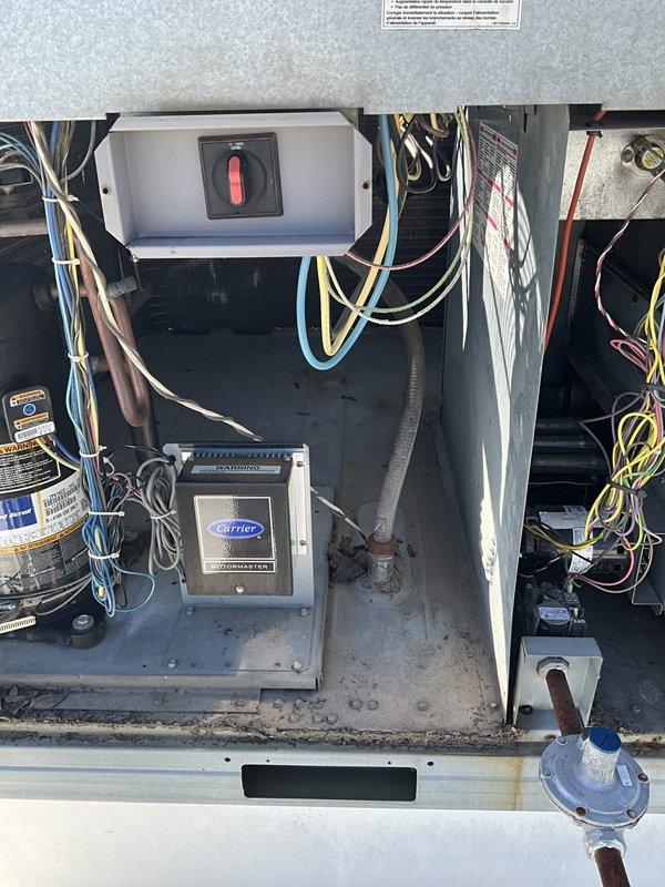 Conducted on-site evaluation of existing rooftop unit at fire station facility to provide replacement estimate. Inspected RTU electrical control components, compressor system, and breathing air compressor integration. Documented equipment condition through detailed photography of control panel, capacitor, wiring configuration, and Carrier-branded control box for accurate system specification and replacement proposal.