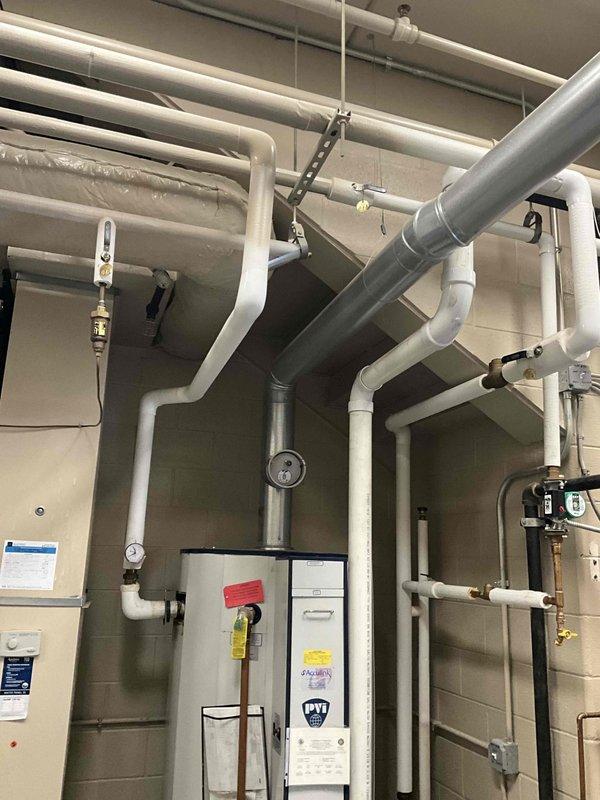 Completed replacement of 100-gallon commercial tanked water heater in mechanical room. Removed existing unit and installed new water heater with proper venting, pressure relief valve, expansion tank, and all required plumbing connections including hot and cold water lines with appropriate shut-off valves. System tested and verified operational with no leaks detected.