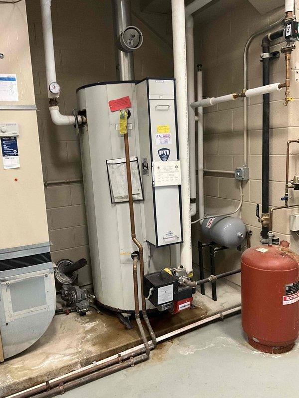 Completed replacement of 100-gallon commercial tanked water heater in mechanical room. Removed existing unit and installed new water heater with proper venting, pressure relief valve, expansion tank, and all required plumbing connections including hot and cold water lines with appropriate shut-off valves. System tested and verified operational with no leaks detected.