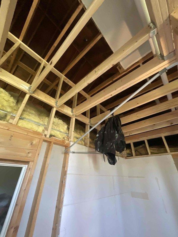 Completed HVAC estimate for mini split installation in bedroom area currently under construction. Assessed exposed ceiling joists, wall framing, and insulation configuration to determine optimal equipment placement and refrigerant line routing. Documented existing conditions including partial drywall installation and structural layout to provide accurate scope of work for ductless heat pump system installation.