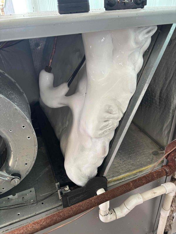 Responded to service call for air conditioning system that failed over the weekend. Upon inspection, discovered extensive ice buildup on evaporator coil and refrigerant lines, indicating restricted airflow or possible low refrigerant charge. Identified heavily soiled return air grate contributing to reduced system airflow. Thawed frozen coil, cleaned return air filter and grate to restore proper airflow, and verified system operation. Unit returned to normal cooling function with indoor temperature at 78°F.