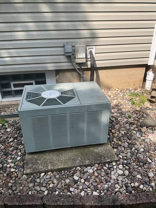 Responded to no cooling call where customer reported air conditioning system not operating and fan not turning on. Upon arrival, performed system inspection of outdoor condensing unit and indoor air handler equipment. Conducted visual assessment of outdoor unit positioned on concrete pad, verified electrical disconnect and power supply connections at exterior wall mounting. Inspected indoor furnace and air handler assembly in basement utility area, examined PVC venting configuration and ductwork connections. Completed diagnostic evaluation but no trouble found during service visit. System components appeared properly installed with appropriate ventilation and electrical service in place.