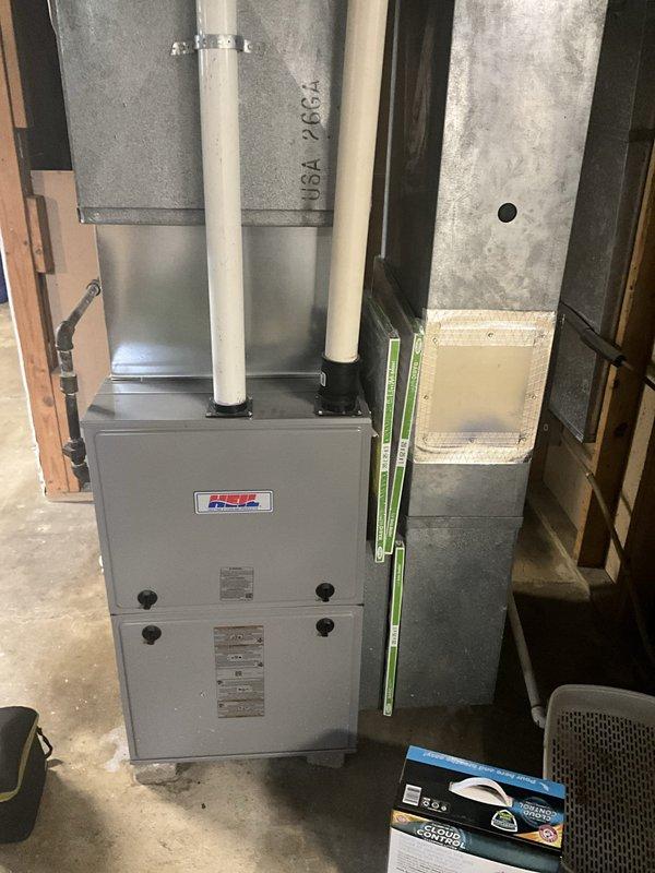 Responded to no cooling call where customer reported air conditioning system not operating and fan not turning on. Upon arrival, performed system inspection of outdoor condensing unit and indoor air handler equipment. Conducted visual assessment of outdoor unit positioned on concrete pad, verified electrical disconnect and power supply connections at exterior wall mounting. Inspected indoor furnace and air handler assembly in basement utility area, examined PVC venting configuration and ductwork connections. Completed diagnostic evaluation but no trouble found during service visit. System components appeared properly installed with appropriate ventilation and electrical service in place.