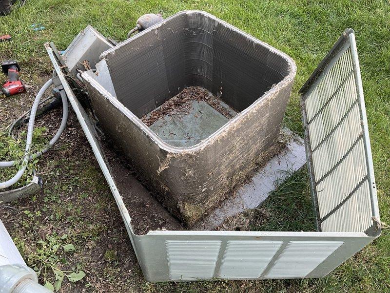 Completed comprehensive BFMA tune-up service on 16-year-old outdoor air conditioning unit. Disassembled cabinet panels to access interior components, which revealed heavy accumulation of dirt, debris, leaves, and organic matter throughout the unit. Performed thorough cleaning of condenser coil, internal components, and cabinet assembly, removing all accumulated contamination to restore proper airflow and system efficiency. Inspected refrigerant lines, electrical connections, and all mechanical components during service. Reassembled unit and verified proper operation upon completion of maintenance protocol.