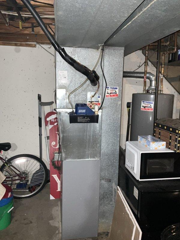 Completed comprehensive BFMA tune-up service on residential HVAC system including outdoor air conditioning condenser unit and indoor furnace/air handler located in basement utility area. Performed full system inspection, cleaned condenser coils, checked refrigerant levels, inspected electrical connections and controls, verified blower motor operation, replaced air filter, tested thermostat functionality, and confirmed proper airflow throughout ductwork. Equipment is approximately 5+ years old and both units are operating within normal parameters following maintenance service.