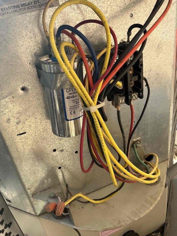 Completed comprehensive BFMA tune-up maintenance on air conditioning system over 4 years old. Performed thorough inspection of electrical components including capacitor, contactor, and starting relay kit with all wiring connections verified secure and properly terminated. Inspected compressor unit and refrigerant lines for proper operation, checked all mounting hardware and mechanical components for secure installation, and documented system condition with detailed photographs of internal control panel and exterior unit components.
