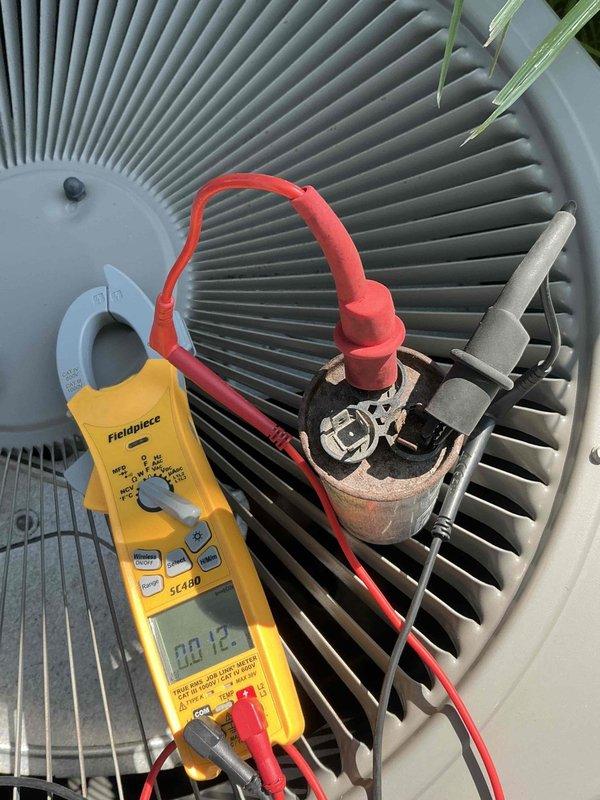 Responded to no cooling complaint on 8-year-old air conditioning system. Upon arrival, confirmed system was running but not providing adequate cooling or dehumidification throughout the home. Accessed outdoor condenser unit and performed electrical diagnostics using clamp meter to check amperage draw and component operation. Inspected control board wiring, connections, and dual-run capacitor. Testing revealed failed capacitor preventing compressor from operating properly. Replaced defective capacitor with new unit, verified proper electrical connections, and tested system operation. Confirmed compressor startup, normal amperage draw, and proper cooling cycle restoration. System returned to normal operation with adequate cooling capacity.