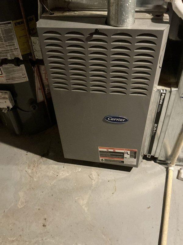 Conducted estimate for complete air conditioning system and evaporator coil replacement. Existing Carrier furnace and AC system is over 15 years old and has reached end of serviceable life. Documented current equipment configuration including furnace installation in basement utility area with associated ductwork, water heater, and plumbing connections. Assessed space requirements and clearances for new equipment installation. Provided recommendations for appropriately sized replacement AC unit and compatible evaporator coil to match existing furnace system.