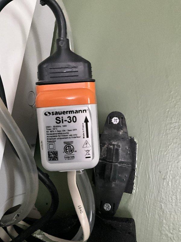 Responded to service call for leaking mini split system. Inspected Carrier outdoor condenser unit and indoor air handler installation. Found condensate drainage issue causing water leakage from indoor unit. Installed Sauermann SI-30 condensate removal pump with wall-mounted bracket to address inadequate gravity drainage. Connected discharge tubing and verified proper pump operation and automatic cycling. Tested system under normal operating conditions to confirm leak resolution and proper condensate removal.