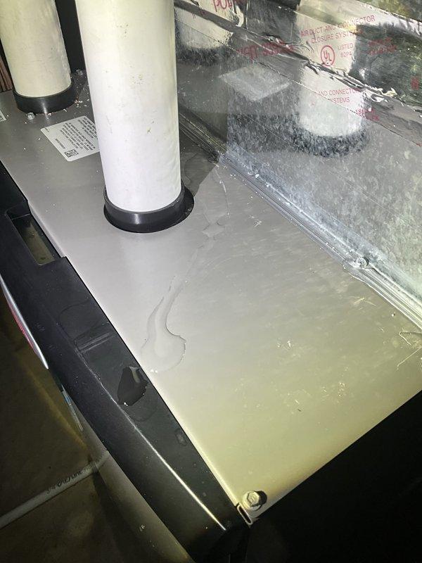 Responded to water leak from residential HVAC unit. Upon inspection, found significant standing water accumulated in the condensate drain pan with visible moisture on surrounding components and glass panel. System was still providing cooling but showed signs of potential drainage obstruction or freeze-up condition. Instructed occupant to turn off air conditioning and run fan only to prevent ice formation until follow-up service appointment could be completed for further diagnosis and repair of drainage system.
