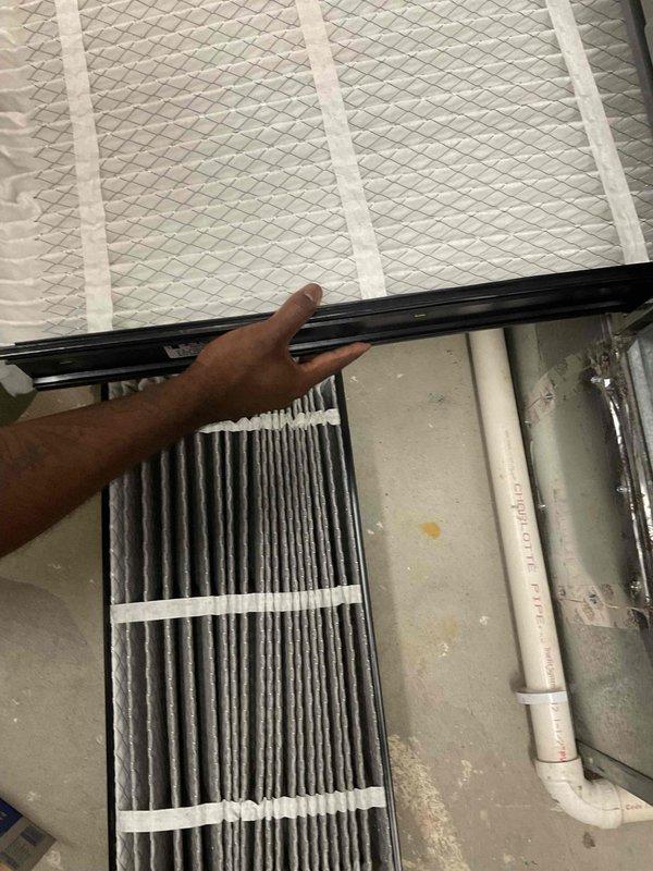 Completed BFMA tune-up service as first stop of the day. Accessed HVAC system in attic space and performed filter replacement on air handling unit. Removed heavily soiled pleated air filter showing significant dust and debris accumulation, replaced with new clean pleated filter to restore proper airflow and system efficiency. Inspected ductwork and equipment condition during service.