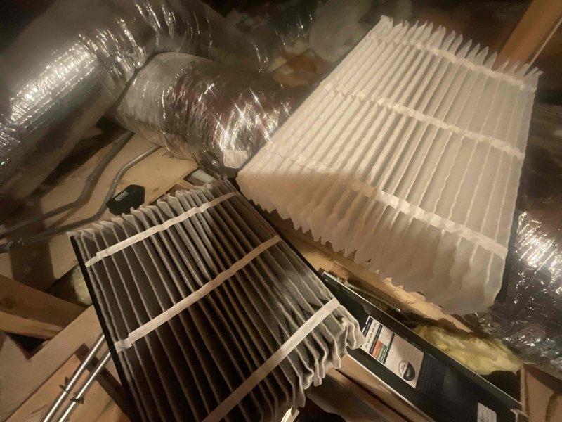 Completed BFMA tune-up service as first stop of the day. Accessed HVAC system in attic space and performed filter replacement on air handling unit. Removed heavily soiled pleated air filter showing significant dust and debris accumulation, replaced with new clean pleated filter to restore proper airflow and system efficiency. Inspected ductwork and equipment condition during service.