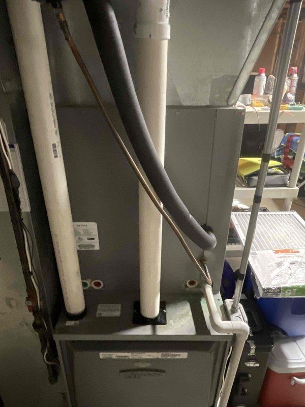 Responded to no cooling complaint affecting entire residence. Upon arrival, inspected air handler and furnace unit located in basement mechanical room. Evaluated refrigerant lines, condensate drainage system, and overall HVAC equipment operation. Documented equipment condition and system components including insulated refrigerant piping and PVC condensate lines for service records.