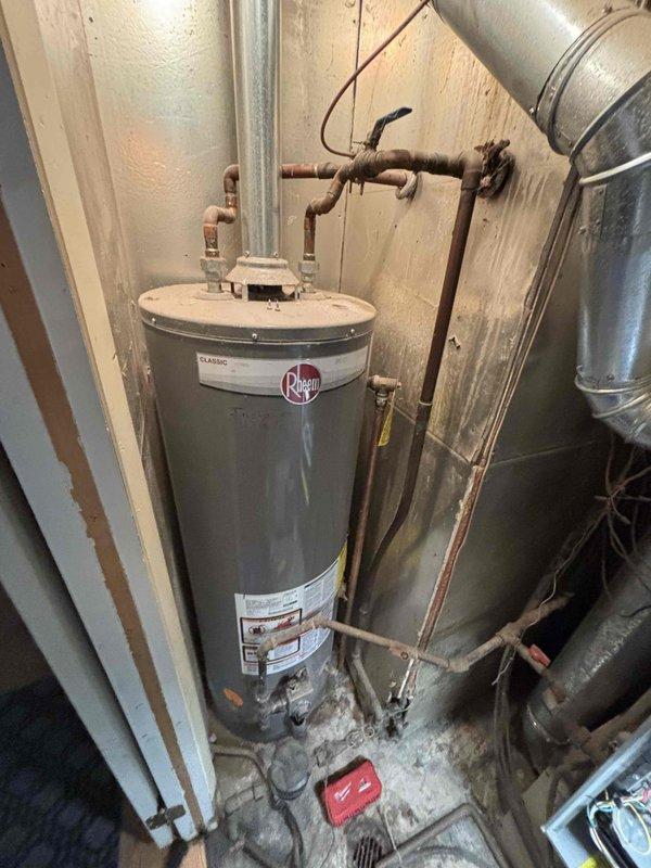 Completed comprehensive furnace tune-up on 13+ year old heating system. Performed standard maintenance protocol including inspection of all mechanical components, burner assembly cleaning, heat exchanger examination, and safety control testing. Verified proper operation of gas valve, ignition system, and flame sensor. Checked and adjusted airflow, tested thermostat functionality, and confirmed adequate combustion air supply. Inspected venting system for proper draft and clearances. Evaluated condition of water heater plumbing connections and observed aged copper piping with typical oxidation throughout utility area. All furnace components found operational within acceptable parameters for unit age. System running efficiently with no immediate safety concerns identified. Documented equipment condition with photographs for service records.
