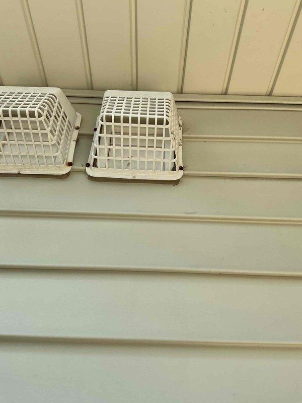 Completed dryer vent cleaning service at residential property. Accessed exterior vent terminations mounted on building siding and thoroughly cleaned flexible duct run from dryer appliance to exterior discharge point, removing accumulated lint, debris, and obstructions to restore proper airflow and reduce fire hazard. Verified unobstructed airflow through both interior and exterior vent components upon completion.