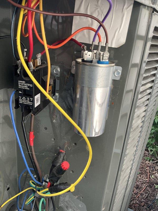 Responded to service call for air conditioning system not maintaining desired temperature. Customer reported thermostat set to 68°F but indoor temperature reading 75°F. Performed diagnostic evaluation of Trane outdoor condensing unit and electrical components. Inspected capacitor, contactor (model DY67B27P02), and associated wiring connections. Verified all electrical connections secure with proper wire routing and management. Examined outdoor unit placement on concrete pad, confirmed adequate clearance and airflow around condenser. System evaluated for proper operation of compressor and fan motor circuits.