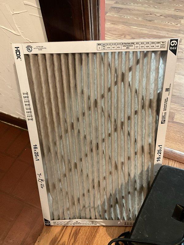 Completed comprehensive furnace tune-up on 5-year-old Amana unit for new homeowner requesting preventive maintenance inspection. Performed full system evaluation including combustion analysis, heat exchanger inspection, blower assembly cleaning, and safety control testing. Identified sandy material discharge from flue pipe requiring monitoring and potential future remediation. Replaced dirty 16x25x1 air filter that showed significant dust accumulation. Noted thermostat location behind television may be causing inefficient cycling and recommended upgrade to wireless thermostat for improved placement and system efficiency. All safety controls tested within normal parameters, burner assembly cleaned, and unit operating properly at conclusion of service.