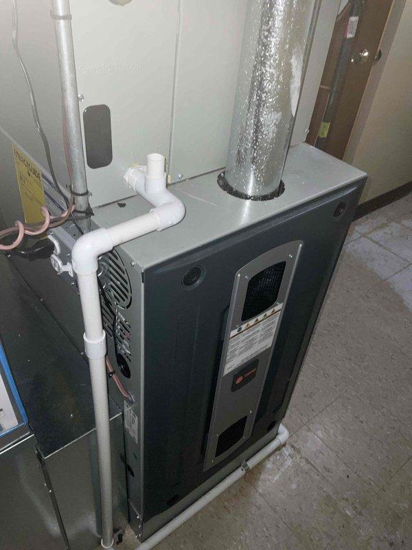 Completed comprehensive BFMA tune-up service on residential HVAC system including both furnace and air conditioning units, both over 3 years old. Performed full inspection of gray-green furnace unit with integrated air handler, verified proper operation of all mechanical components, checked gas valve assembly and control mechanisms, and inspected PVC venting system for proper drainage and secure connections. Evaluated flexible ductwork connections, tested system airflow, and confirmed furnace burner operation and heat exchanger integrity.