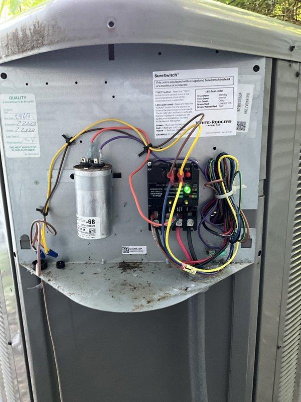 Responded to no cooling complaint on four-month-old residential air conditioning system under warranty. Upon inspection, discovered failed condenser fan motor preventing proper heat rejection from outdoor unit. Removed defective Genteq motor assembly and documented component failure with photographic evidence for warranty claim processing. Replaced motor, verified proper electrical connections at capacitor and control board, and restored system to normal cooling operation.