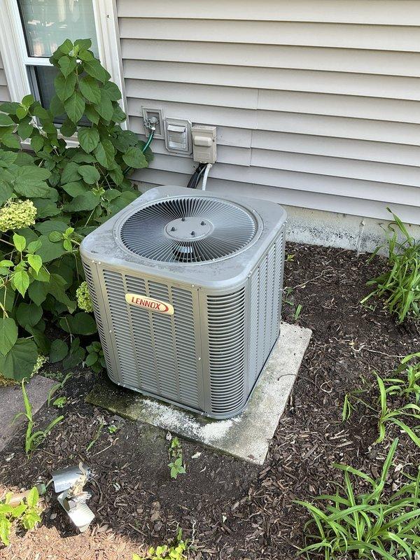 Responded to service call for non-operational air conditioning system that had been inoperative for several days. Upon arrival, inspected existing Lennox outdoor condensing unit installed on concrete pad adjacent to home foundation. Unit appeared to be over five years old with concerns regarding original installation quality. Evaluated system placement, electrical connections, refrigerant lines, and overall equipment condition. Documented current installation configuration including condenser positioning, electrical service connections mounted on exterior wall, and line set routing through landscaped area. Provided comprehensive estimate for air conditioning system and evaporator coil replacement to address operational failure and correct any previous installation deficiencies.