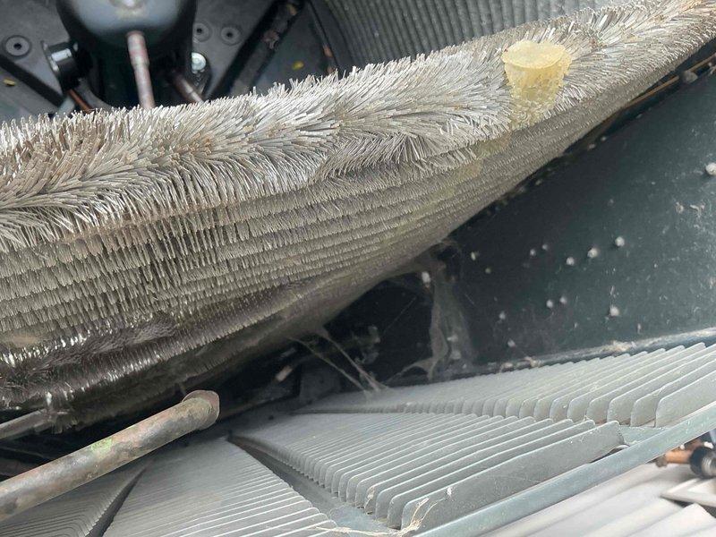 Responded to after hours call for HVAC system malfunction. Upon arrival, found Goodman model LBA029CT CLA compressor unit with severe evaporator coil freeze-up. Heavy frost and ice accumulation observed throughout coil fins, with crystalline buildup extending significantly from coil surface. Identified operational issue causing excessive refrigeration cycle problems leading to complete coil icing. Documented equipment condition with photographs showing extent of frost damage on heat exchanger components and surrounding refrigerant lines. System required immediate shutdown to prevent compressor damage and allow proper defrost cycle before further diagnostics could be performed.