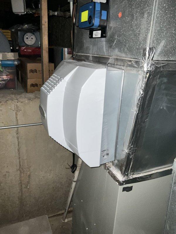 Responded to no cooling call where unit was attempting to run but failing to start properly. Upon inspection, found blower motor assembly with electrical connections intact but motor failing to achieve full operation. Examined motor capacitors, wiring harness connections, and grounding wire at copper mounting bracket. Verified proper electrical connections on all colored wire leads and confirmed secure mounting within metal enclosure. Inspected associated HVAC system including humidifier unit and ductwork connections. System restored to proper cooling operation.