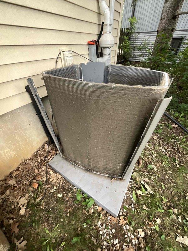 Completed comprehensive BFMA tune-up service on residential split system HVAC unit, including outdoor Carrier condenser positioned on concrete pad and indoor furnace/air handler located in basement utility area. Performed standard maintenance procedures including inspection of all major components, refrigerant line connections, electrical conduits, PVC condensate drainage system, and verified proper operation of all equipment with no trouble found during inspection.
